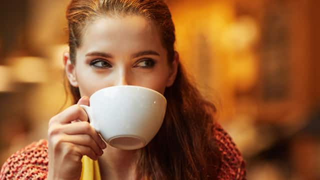 Young woman drinking coffee in a cafe Young woman drinking coffee in a cafe