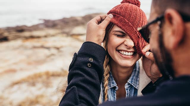 Couple enjoying themselves on a winter day while smiling