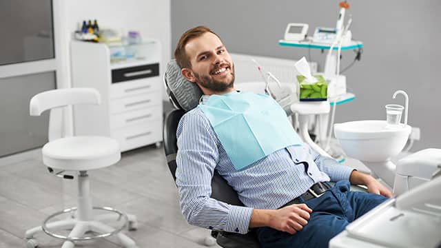 Portrait of happy patient in dental chair