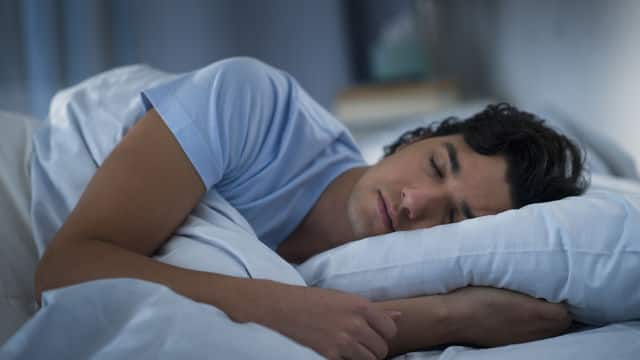 a man sleeping on a bed