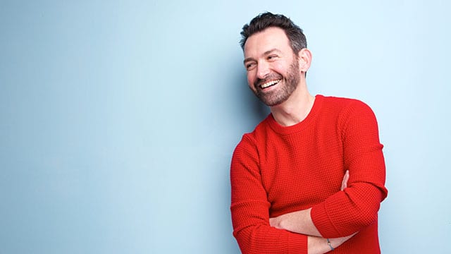 A man smiling indoors