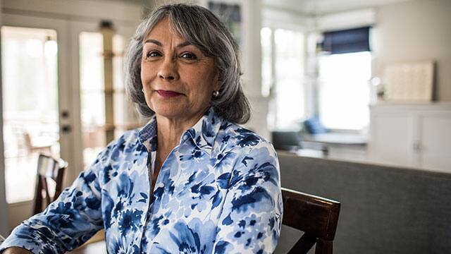 Middle age woman is sitting in a chair