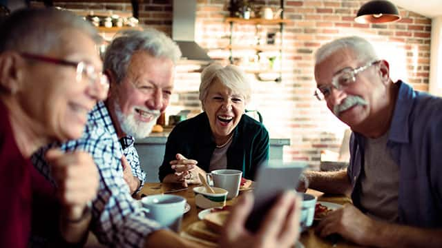 A group of middle age people laughing indoors