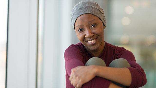 A woman wearing a beanie inside