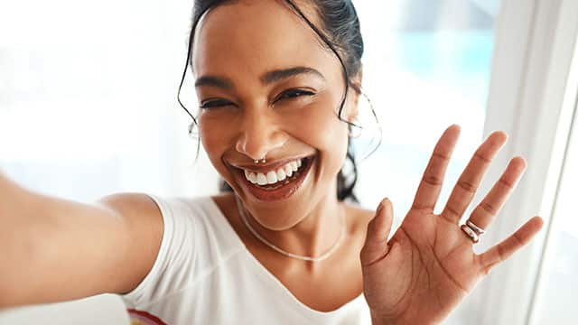 U young woman is stretching her arms and smiling