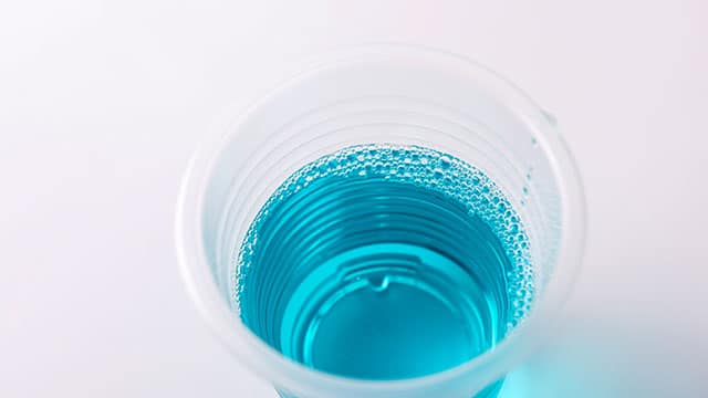 Closeup of a cup of mouthwash on a counter