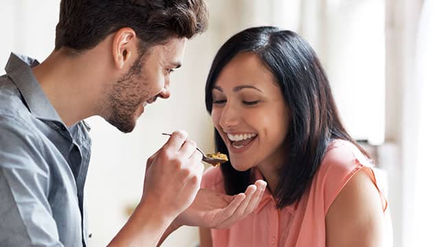 Young couple tasting vegetable stew