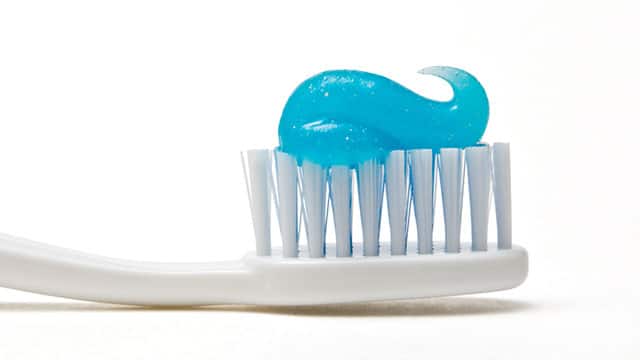 A close up of the toothpaste on a toothbrush