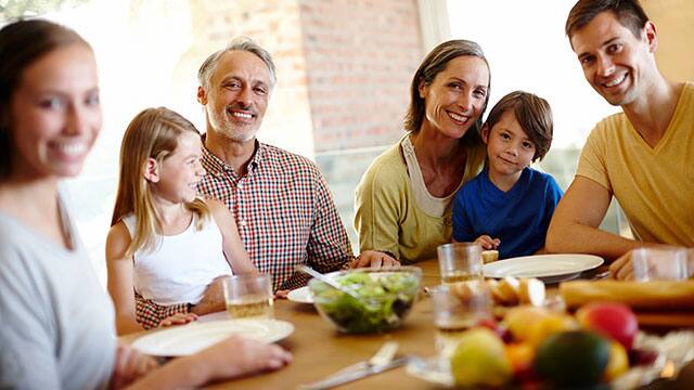 Grandparents with children and grandchildren at the dinner table