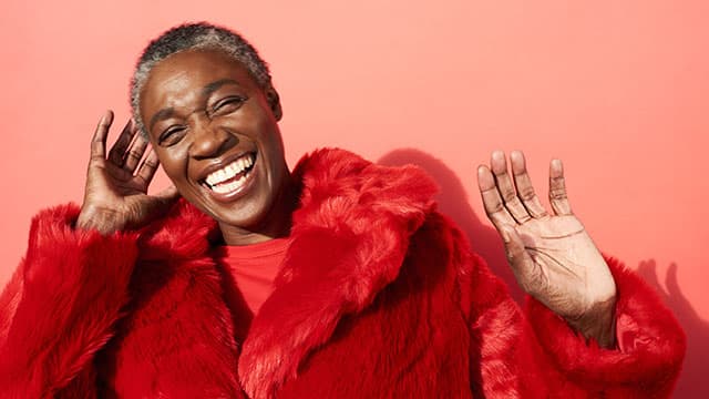 A middle age woman smiling indoors