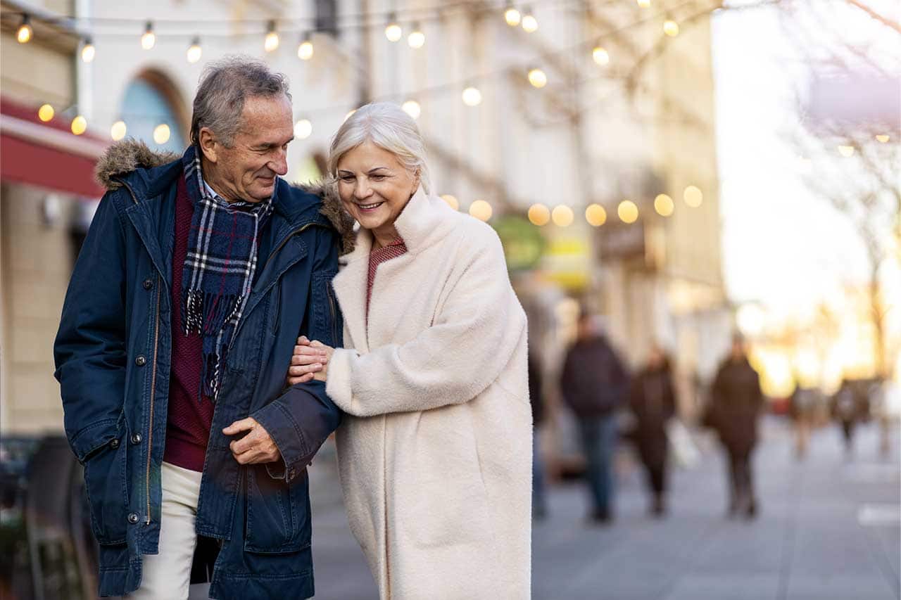 Senior couple walking on the city street on a winter day