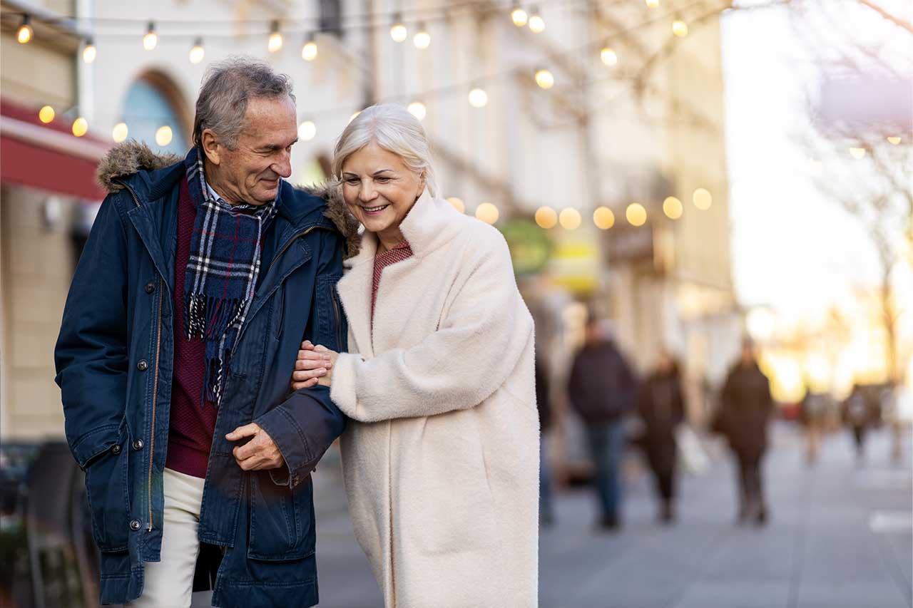 Senior couple walking on the city street on a winter day Senior couple walking on the city street on a winter day