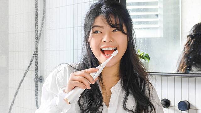 Woman Brushing Teeth