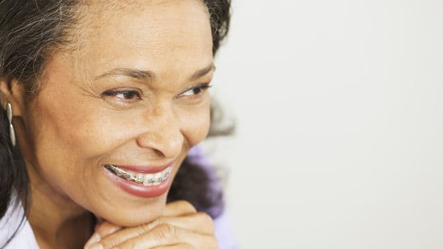 an elderly woman with braces smiling brightly