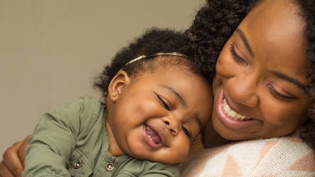 mother and daughter smiling while hugging mother and daughter smiling while hugging