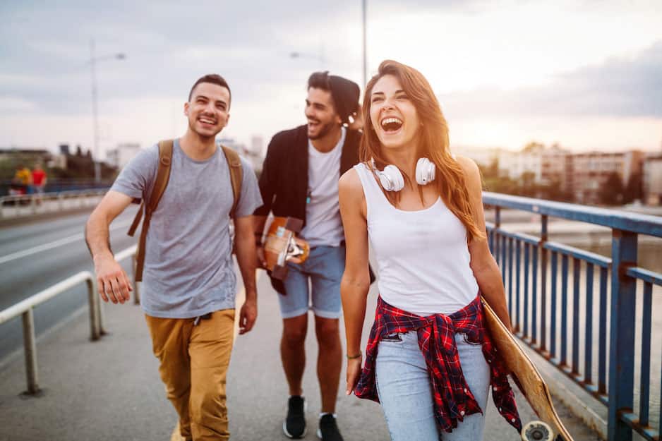 three friends laughing on a bridge