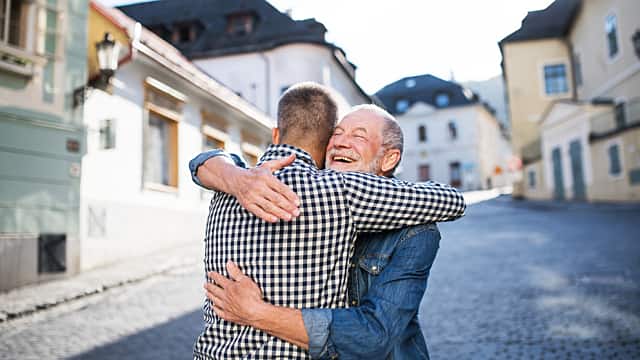 Father hugging his son outdoors