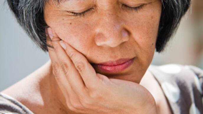 Woman in pain holding her face