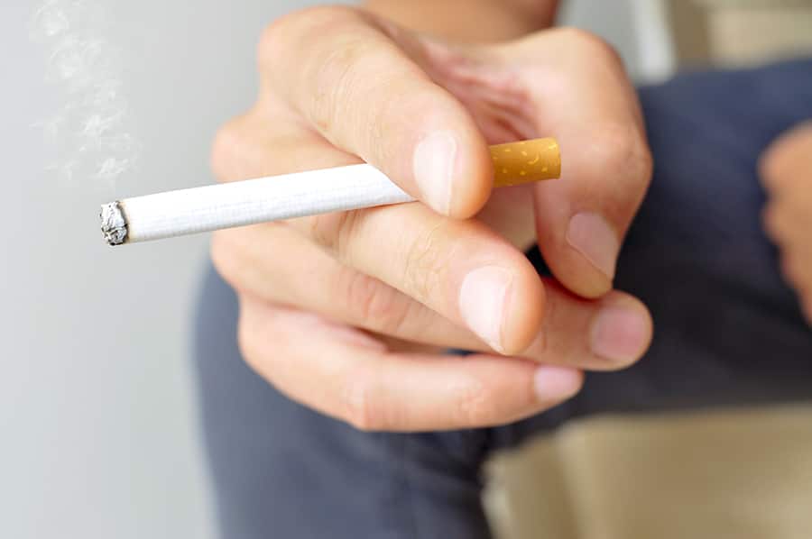 a young man smoking a cigarette