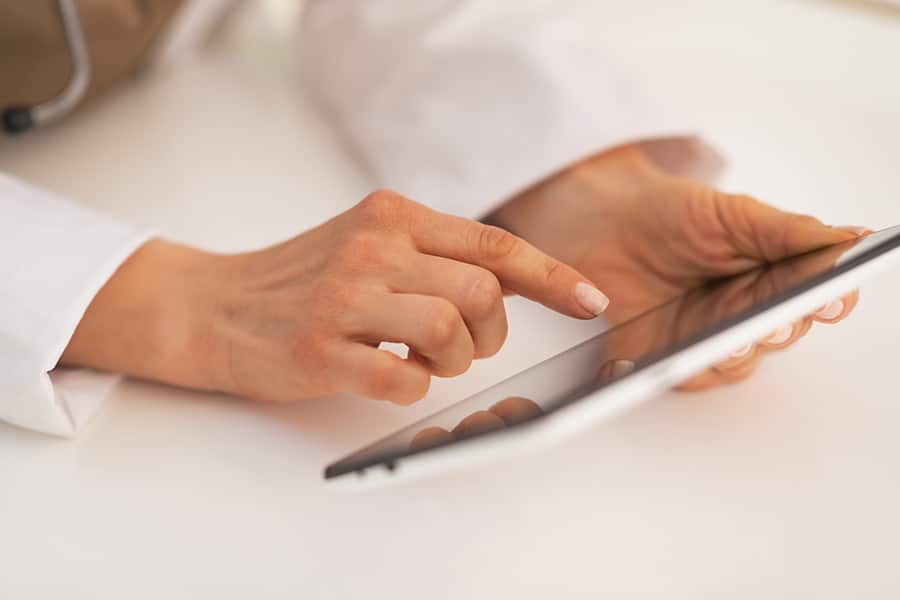 Close up of a female doctor using a tablet