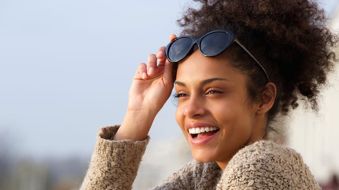 women smiling while looking at the sky