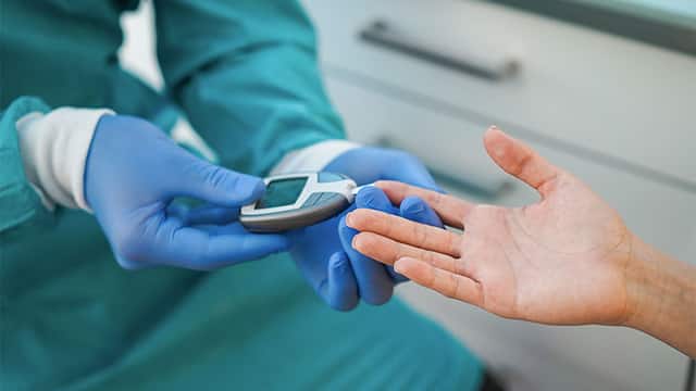 Doctor checking blood sugar