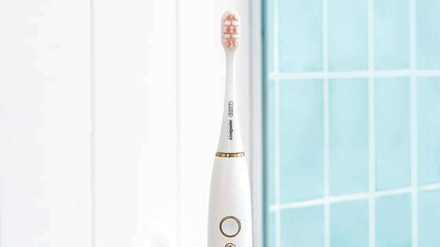 Electric toothbrush on blue background