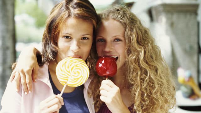 Two women eating sweet