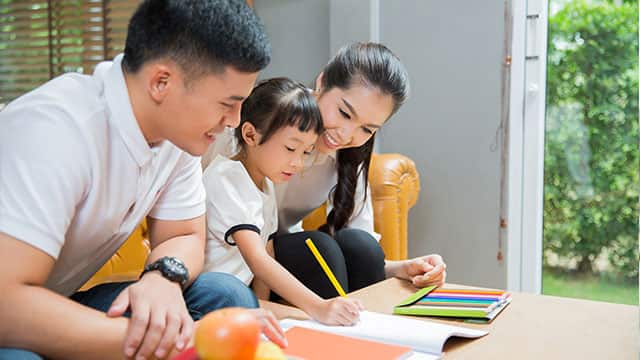 Parents teaching their daughter about food pyramid