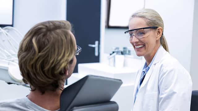 Female Dentist interacting with male Patient Female Dentist interacting with male Patient