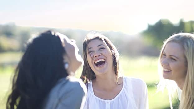 three women laughing outdoor