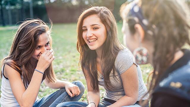 Group of affectionate teenagers in the park Group of affectionate teenagers in the park