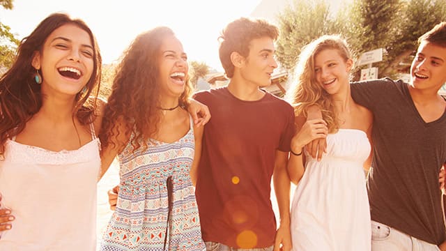 group of friends smiling and walking