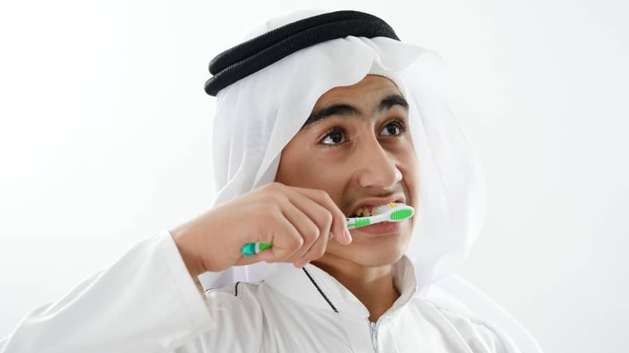 Arabic kid brushing teeth