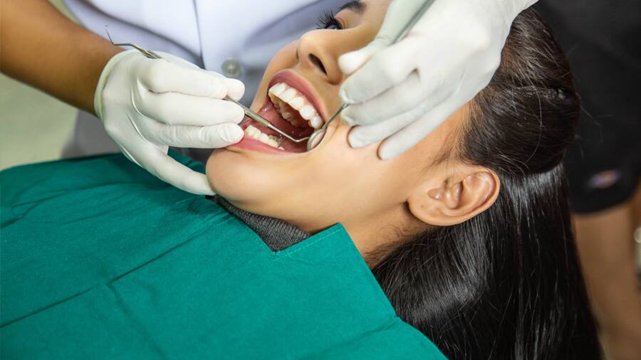 Dentist showing how to remove tooth cavity