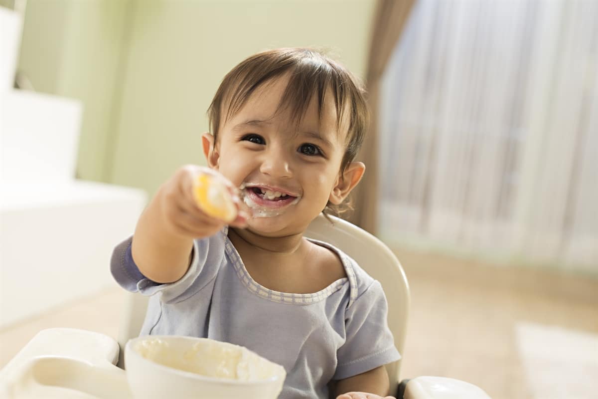 Baby eating and smiling