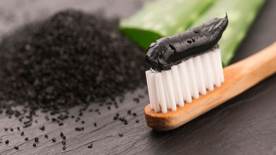 Toothbrush with black charcoal toothpaste