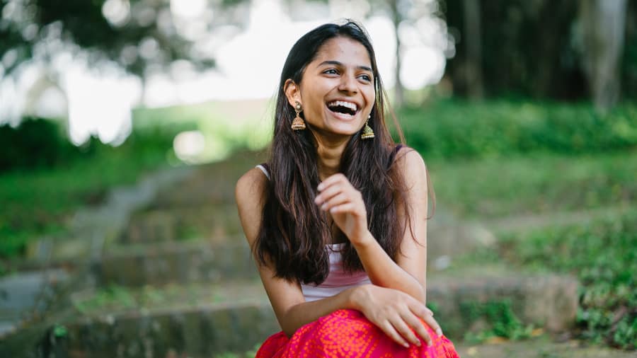 A girl smiling, showcasing whiten teeth at home