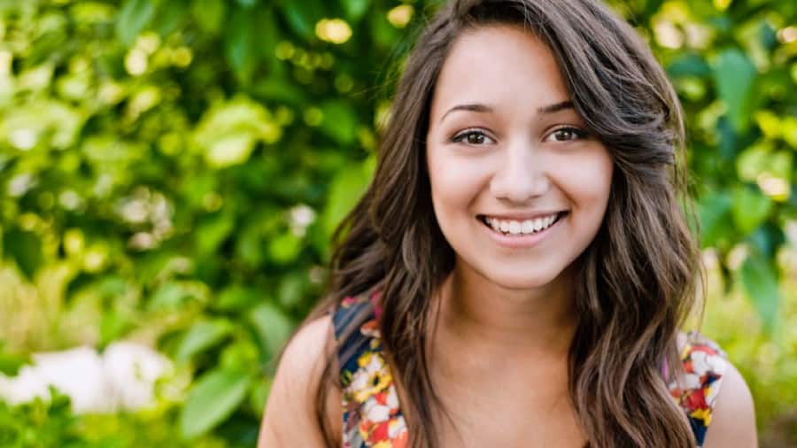 Smiling girl showcases whitened teeth