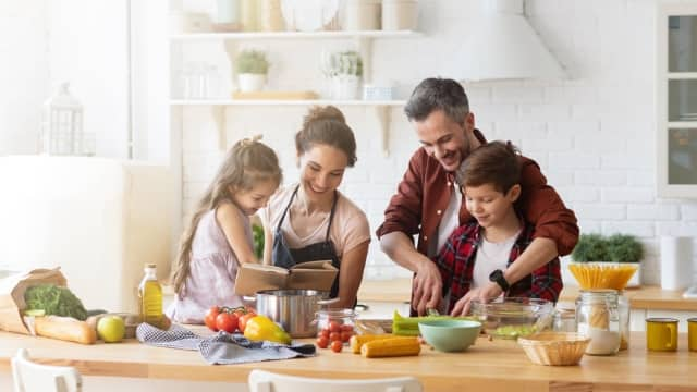 Happy family in the kitchen cooking together