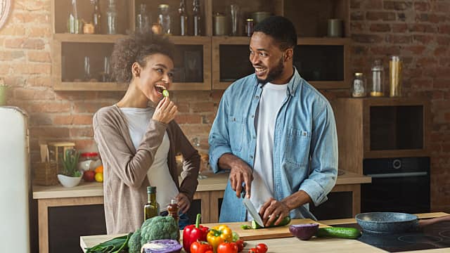 A young couple is cooking in the kitchen together