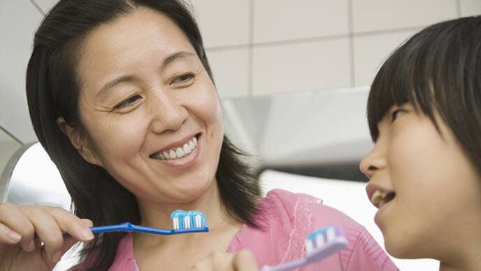mom and son brushing their teeth