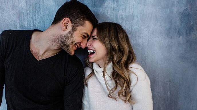 young couple smiling at eachother