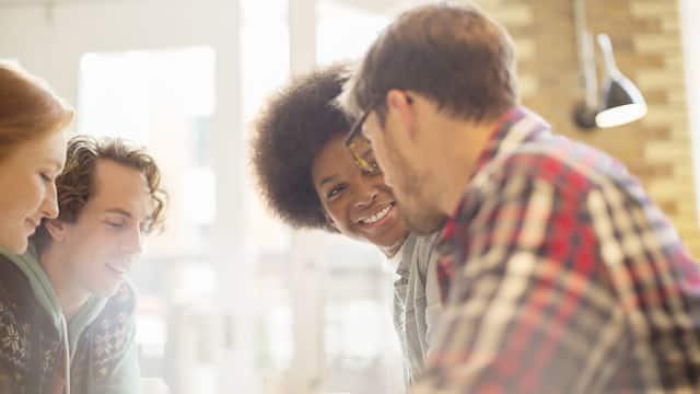 a group of people smiling while chatting