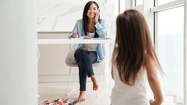 Mother Calling Emergency Dentist While Watching Her Daughter