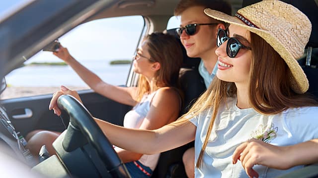 Three friends in a moving car