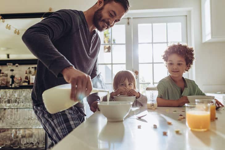 Father preparing breakfast for his kids