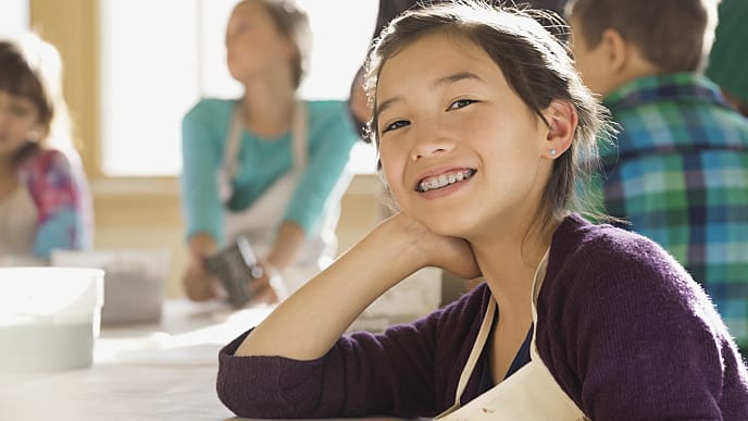 teenager wearing braces reading magazine