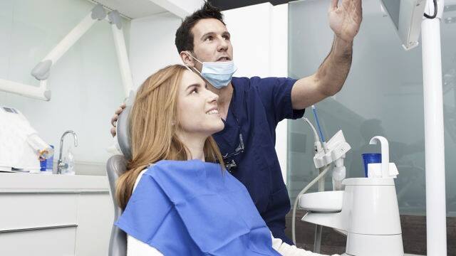 Woman getting tooth decay treatment