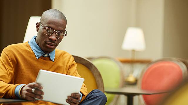 man wearing glasses looking at documents